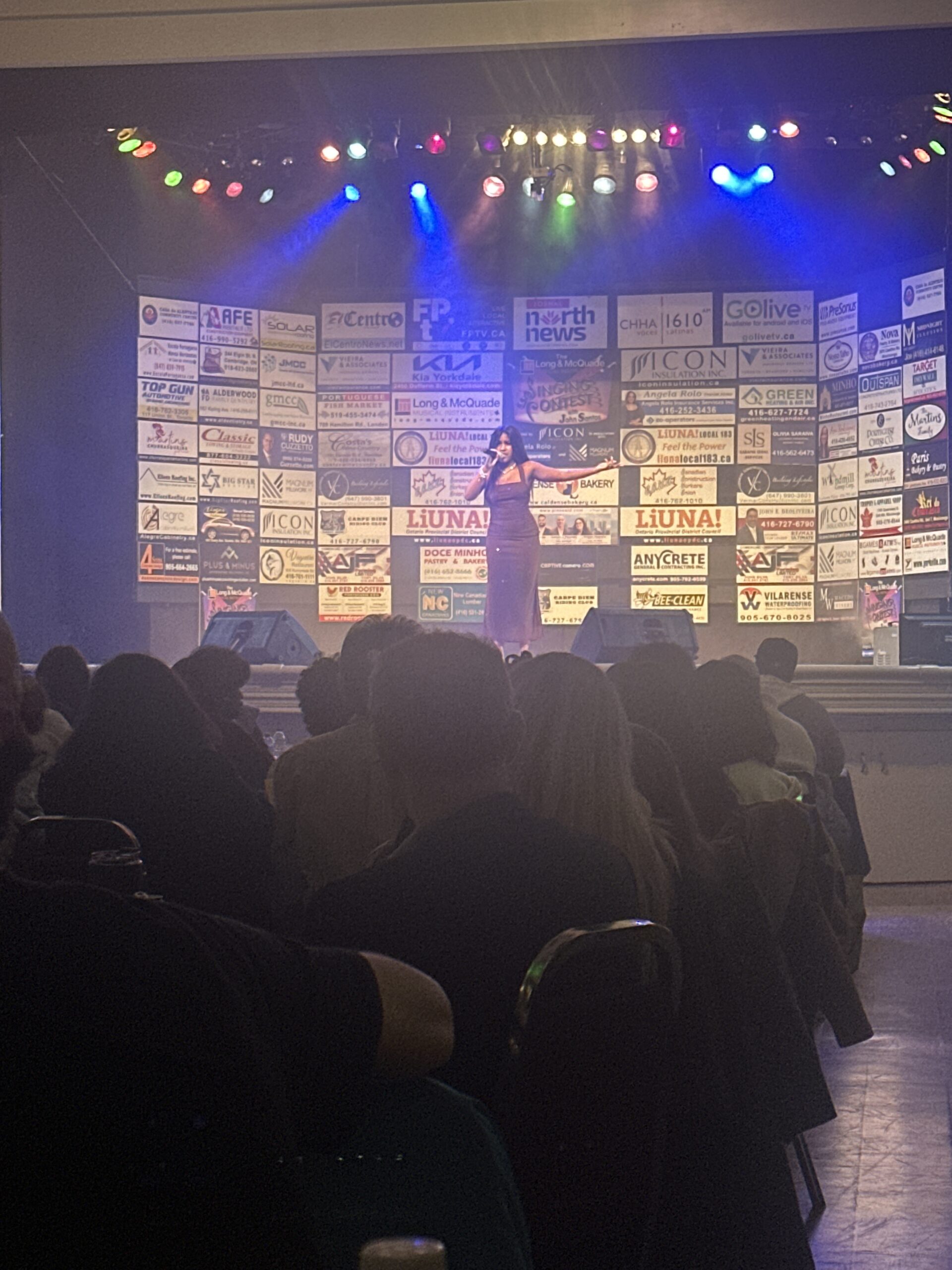Dianela Hernandez Oxamendis performing Bidi Bidi Bom Bom at the Singing Contest with John Santos.